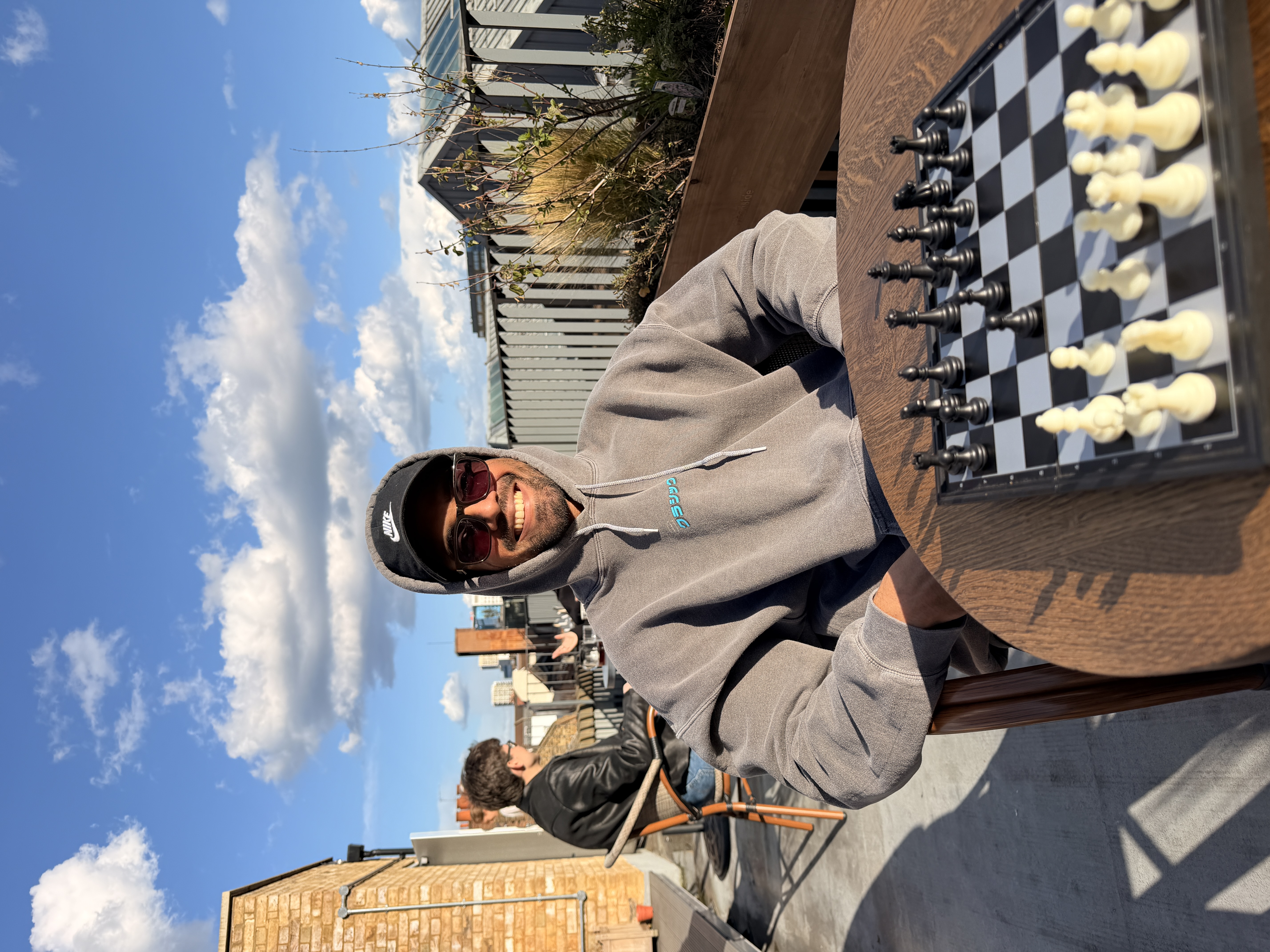 Aryan Mehta, smiling, in a park in London